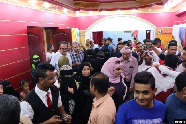 People crowd outside a wedding hall where the local movie "10 Days Before the Wedding" is being played in Aden, Yemen, Sept. 1, 2018.