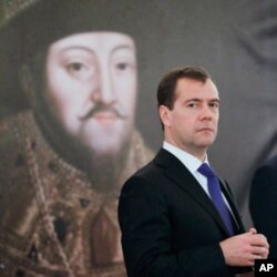 Russian President Dmitry Medvedev stands in front of a picture of Russian Czar Mikhail at the opening ceremony of the exhibition 'Czar's court under the Romanovs' scepter' from the Kremlin museums, in Prague, Czech Republic, Dec. 8, 2011.