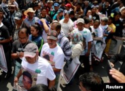 Relatives of 43 missing students who disappeared on Sept. 26, 2014 demonstrate outside the Museum of Memory and Tolerance after a meeting with Mexico's President-elect Andres Manuel Lopez Obrador in Mexico City, Mexico Sept. 26, 2018.