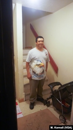 Shown standing at the entrance to his apartment, Guillermo Peralta was arrested by immigration agents on his way to work last February.