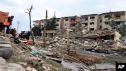 Rescue workers are seen at the scene of a traffic police station and lodging quarters attacked with a car bomb by Kurdish rebels, in Nusaybin, southeastern Turkey, March 4, 2016.