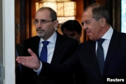   DOSSIER - Russian Foreign Minister Sergei Lavrov and Jordanian Foreign Minister Ayman Safadi enter a room at a meeting in Moscow, Russia, on July 4, 2018. 