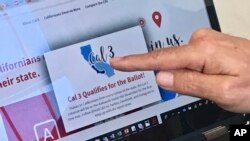 FILE - Venture capitalist Tim Draper points to a computer screen at his offices in San Mateo, Calif., showing that an initiative to split California into three states qualified for the ballot, June 18, 2018.