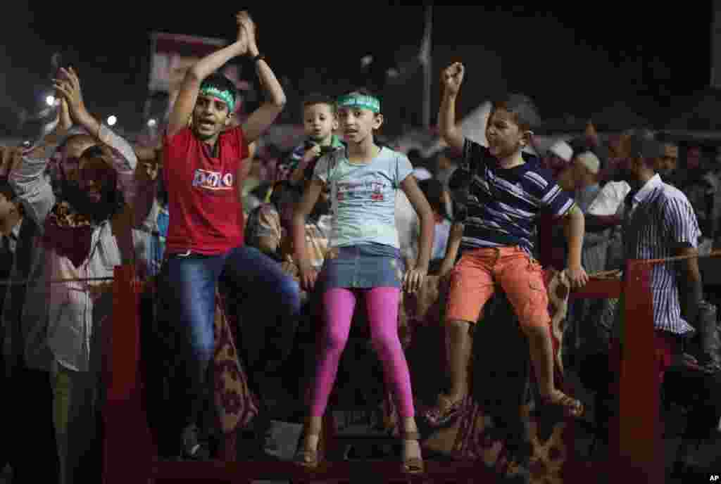 Egyptian children wear head bands with Arabic writing: &quot;No god but Allah and Mohammed is the prophet.&quot; They attend a protest outside Rabaa al-Adawiya mosque, Cairo, Egypt.