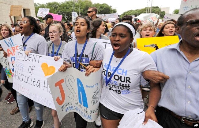 Demonstrators in downtown Houston during a March for Our Lives protest for gun legislation and school safety, March 24, 2018.
