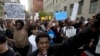 A demonstrator shouts during a protest in downtown Baltimore, Maryland, on April 29, 2015, seeking justice for an African-American man who died of severe spinal injuries sustained in police custody.