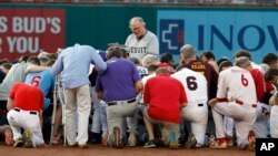 Rev. Patrick J. Conroy, Chaplain of the U.S. House of Representatives, prays as both teams kneel, before the Congressional baseball game, Thursday, June 15, 2017, in Washington. The annual GOP-Democrats baseball game raises money for charity. (AP Photo/Alex Brandon)