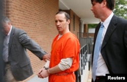 FILE - James Everett Dutschke, flanked by U.S. marshals, arrives for a sentencing hearing at the federal building in Aberdeen, Miss., May 13, 2014.