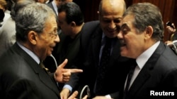 Amr Moussa (L), head of the assembly writing Egypt's new constitution, speaks with El-Sayed El-Badawi (R), the head of the Wafd party, before a vote at the Shura Council in Cairo, Dec. 1, 2013. 