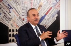 FILE - Turkish Foreign Minister Mevlut Cavusoglu talks at the Foreign Press Club, in Rome, Nov. 23, 2017.