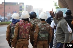 Burkina Faso's soldiers take position in the surroundings of the Splendid hotel following an attack by Al-Qaeda linked gunmen on Jan. 16, 2016 in Ouagadougou.