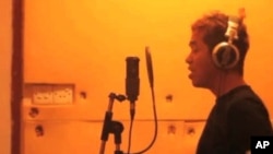 Darko C of the Burmese band Side Effect records vocal tracks.