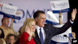 Republican presidential candidate Mitt Romney, right, and his wife Ann wave to a crowd in Schaumburg, Illinois, after Romney won the Illinois Republican presidential primary, March 20, 2012.
