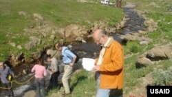 The experts from Environmental Impact Monitoring Center take water sampling together with USAID's Water Resources Management Agency program consultants.