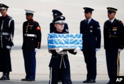 FILE - A soldier carries a casket containing a remain of a U.S. soldier who was killed in the Korean War, during a ceremony at Osan Air Base in Pyeongtaek, South Korea, July 27, 2018.