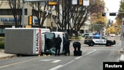 Edmonton Police investigate at the scene where a man hit pedestrians then flipped the U-Haul truck he was driving, in Edmonton, Alberta, Canada, Oct. 1, 2017.