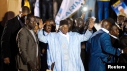 Senegal's former President Abdoulaye Wade greets a crowd upon his arrival in Dakar April 26, 2014.