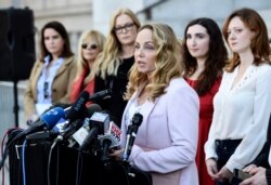 Actress Louisette Geiss addresses the media at a news conference by the "Silence Breakers," a group of women who have spoken out about Hollywood producer Harvey Weinstein's sexual misconduct, at Los Angeles City Hall, Feb. 25, 2020, in Los Angeles.