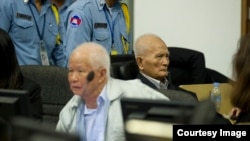Khieu Samphan and Nuon Chea in a 2013 hearing at the Khmer Rouge tribunal. (Courtesy Image of Mark Peters/ECCC)