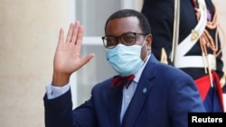 FILE - President of the African Development Bank, M. Akinwumi Adesina waves as he arrives for a dinner with French President Emmanuel Macron and leaders of African states and international organisations on the eve of a summit on aid for Africa, at Elysee 