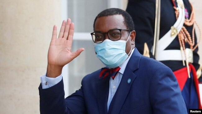 FILE - President of the African Development Bank, M. Akinwumi Adesina waves as he arrives for a dinner with French President Emmanuel Macron and leaders of African states and international organisations on the eve of a summit on aid for Africa, at Elysee