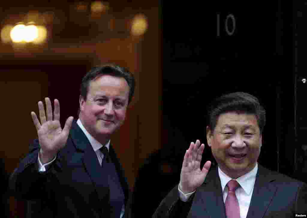 President Xi Jinping is welcomed by Prime Minister David Cameron to 10 Downing Street, in central London, Oct. 21, 2015.