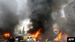 Civilians gather at the of an explosion in Beirut's southern suburb neighbourhood of Bir al-Abed on July 9, 2013. A car bomb rocked Beirut's southern suburbs, stronghold of Lebanon's Shiite Hezbollah movement, wounding 15 people, television reports and 