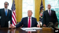 President Donald Trump listens to a reporter's question after signing an executive order to increase sanctions on Iran, in the Oval Office of the White House, Monday, June 24, 2019, in Washington. (AP Photo/Alex Brandon)