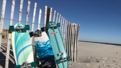 Surfskates line up against white fences at a beach east of New York City, New York, March 2021.