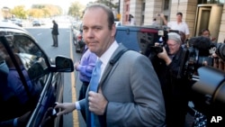 Rick Gates gets into a car as he leave Federal District Court in Washington, Nov. 2, 2017.