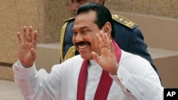 FILE - Sri Lankan President Mahinda Rajapaksa gestures during his swearing-in-ceremony in Colombo, Sri Lanka, Nov. 19, 2010.