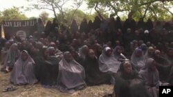 FILE- In this Monday, May.12, 2014 file image taken from video by Nigeria's Boko Haram terrorist network, shows the alleged missing girls abducted from the northeastern town of Chibok.
