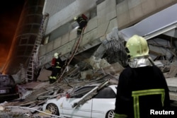 A fireman works at a collapses building after earthquake hit Hualien, Taiwan, Feb. 7, 2018.