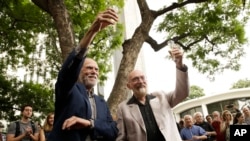 Scientists Barry Barish, left, and Kip Thorne, both of the California Institute of Technology, share a toast to celebrate winning the Nobel prize in physics in Pasadena, Calif., Oct. 3, 2017. 