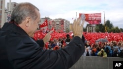 Turkish President Recep Tayyip Erdogan salutes the crowd of supporters in his hometown of Rize, on the Black Sea coast of Turkey, Oct. 15, 2016. Erdogan said Turkey was moving into Dabiq, Syria, and would declare a "terror-free safe zone" in the region.