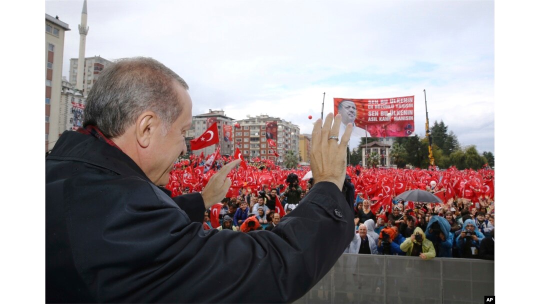 Turkish President Recep Tayyip Erdogan salutes the crowd of supporters in his hometown of Rize, on the Black Sea coast of Turkey, Oct. 15, 2016. Erdogan said Turkey was moving into Dabiq, Syria, and would declare a "terror-free safe zone" in the region.