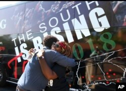 Black Voters Matter co-founder LaTosha Brown, right, gets a hug from a well wisher before departing on The South Is Rising Tour 2018 on Aug. 22, 2018, in Stockbridge, Ga.