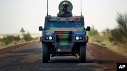 French soldiers in a British made armored car lead a French supply convoy near Hambori, northern Mali, on the road to Gao, February 4, 2013.