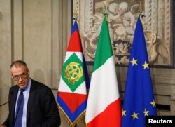 FILE - Former senior International Monetary Fund (IMF) official Carlo Cottarelli speaks to the media after a meeting with Italy's President Sergio Mattarella at the Quirinal Palace in Rome, Italy, May 28, 2018.