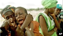 FILE - Health organizations have launched a vaccination campaign to curb the spread of meningitis in Guinea. Here, a youngster cries as he's inoculated in Senegal near the border with Guinea.