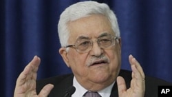 Palestinian President Mahmoud Abbas gestures as he speaks during a press conference with members of the Israeli Peace Initiative in Ramallah, April 28, 2011