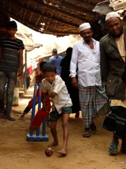 Robaun Alam, 11, plays cricket in an alley at the Kutupalong refugee camp on Feb. 15, 2020. It is almost impossible to practice social distancing in the overcrowded camps. (Hai Do/VOA)