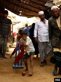 Robaun Alam, 11, plays cricket in an alley at the Kutupalong refugee camp on Feb. 15, 2020. It is almost impossible to practice social distancing in the overcrowded camps. (Hai Do/VOA)
