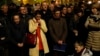 People pray as Notre Dame cathedral is burning in Paris, April 15, 2019.