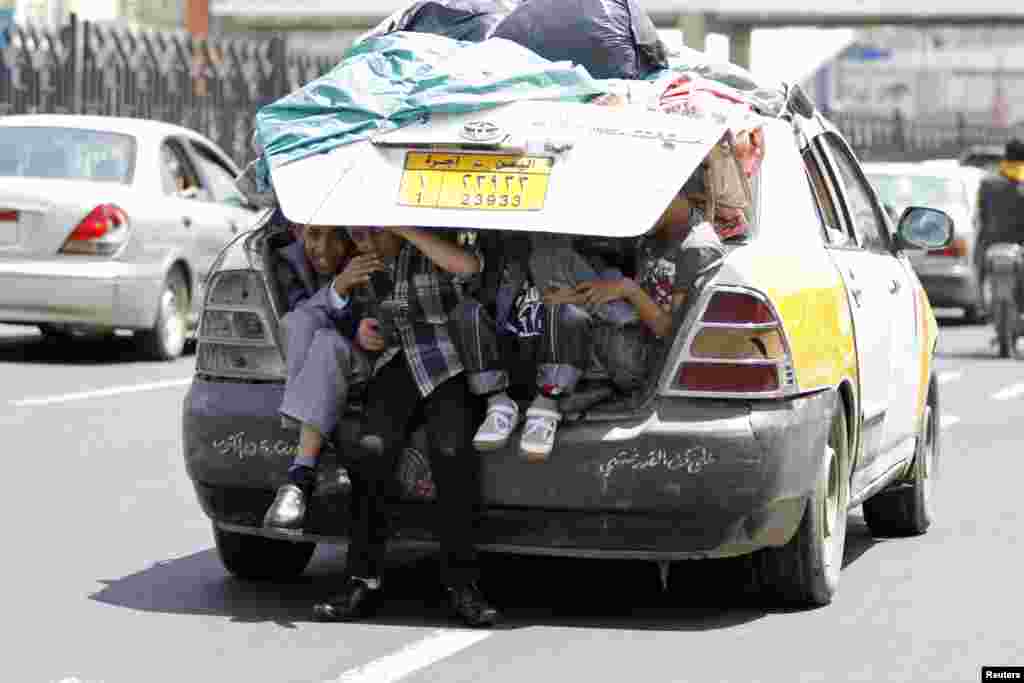 Boys sit in the trunk of a car in Sana&#39;a, Yemen.