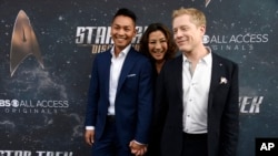 FILE - Anthony Rapp (R), a cast member in "Star Trek: Discovery," poses with his boyfriend Teerakeni and fellow cast member Michelle Yeoh at the premiere of the new television series in Los Angeles, Sept. 19, 2017. 