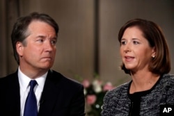 Brett Kavanaugh, left, looks at his wife Ashley Estes Kavanaugh as they answer questions during a FOX News interview, Sept. 24, 2018, in Washington, about allegations of sexual misconduct against the Supreme Court nominee.