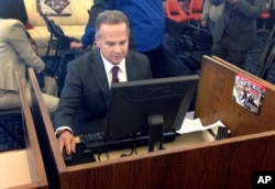 U.S. Rep. David Cicilline completes his test census form on a computer at a library in Providence, R.I., March 26, 2018.