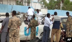 This image made from video shows the scene following a bomb attack on a van carrying U.N. employees in Garowe, in the semi-autonomous Puntland region of northern Somalia, April 20, 2015.
