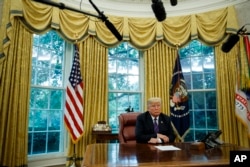 President Donald Trump listens during a phone call with Mexican President Enrique Pena Nieto about a trade agreement between the United States and Mexico, in the Oval Office of the White House, Aug. 27, 2018, in Washington.